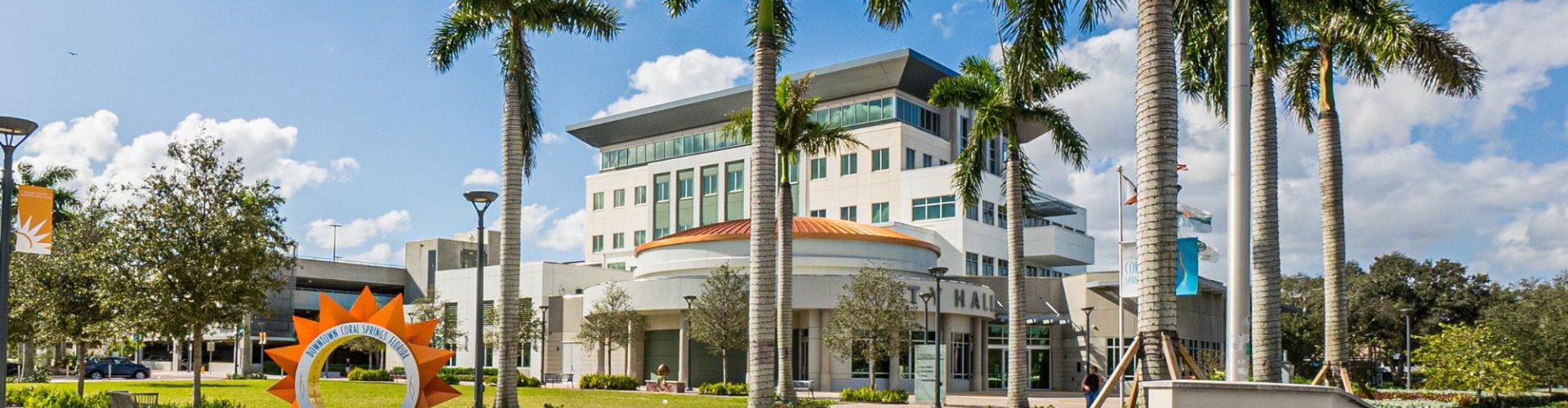 Luxury car cruising through Coral Springs at dusk