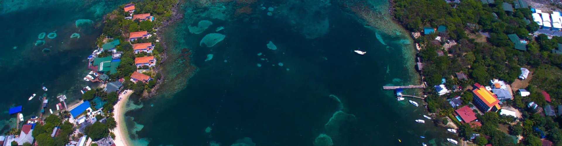 Luxury car parked at Roatán sunset