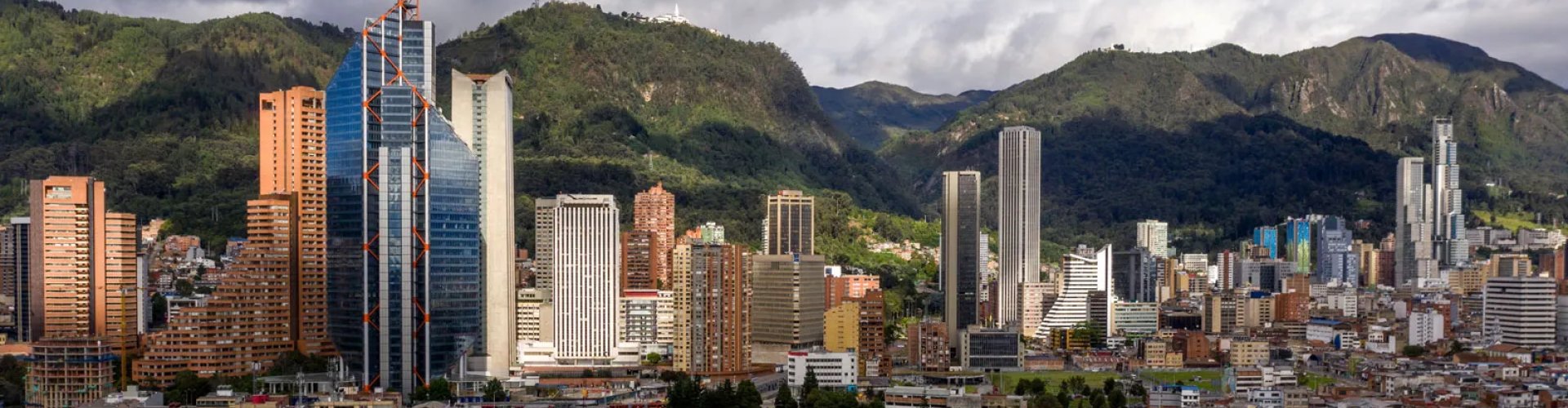 Luxury car cruising through Bogotá skyline
