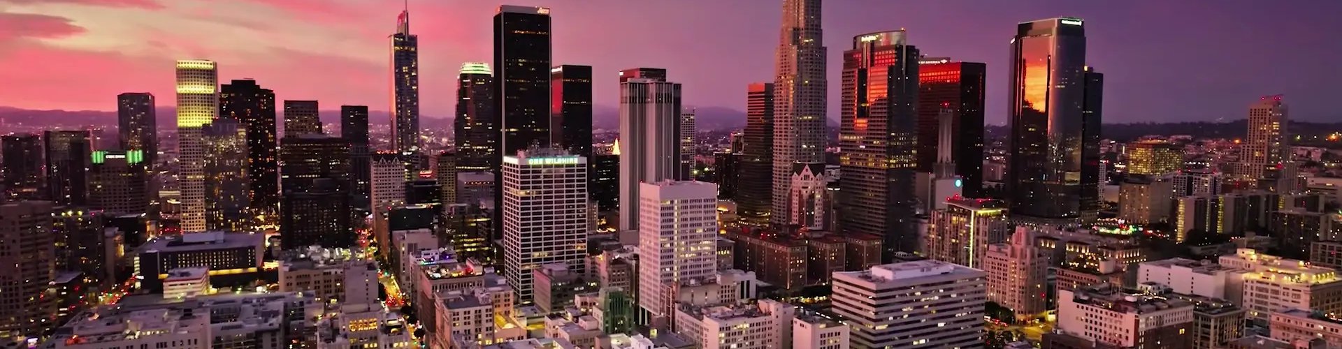 Luxury vehicle cruising Los Angeles skyline